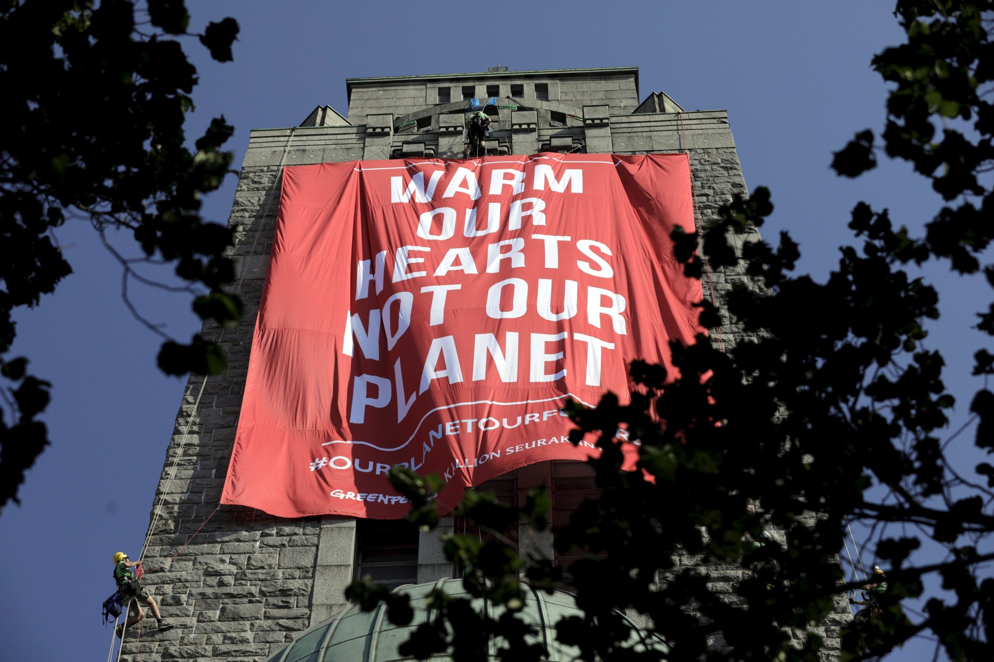 Organizácia Greenpeace zavesila protestný transparent na vežu kostola počas samitu Donalda Trump a Vladimíra Putina